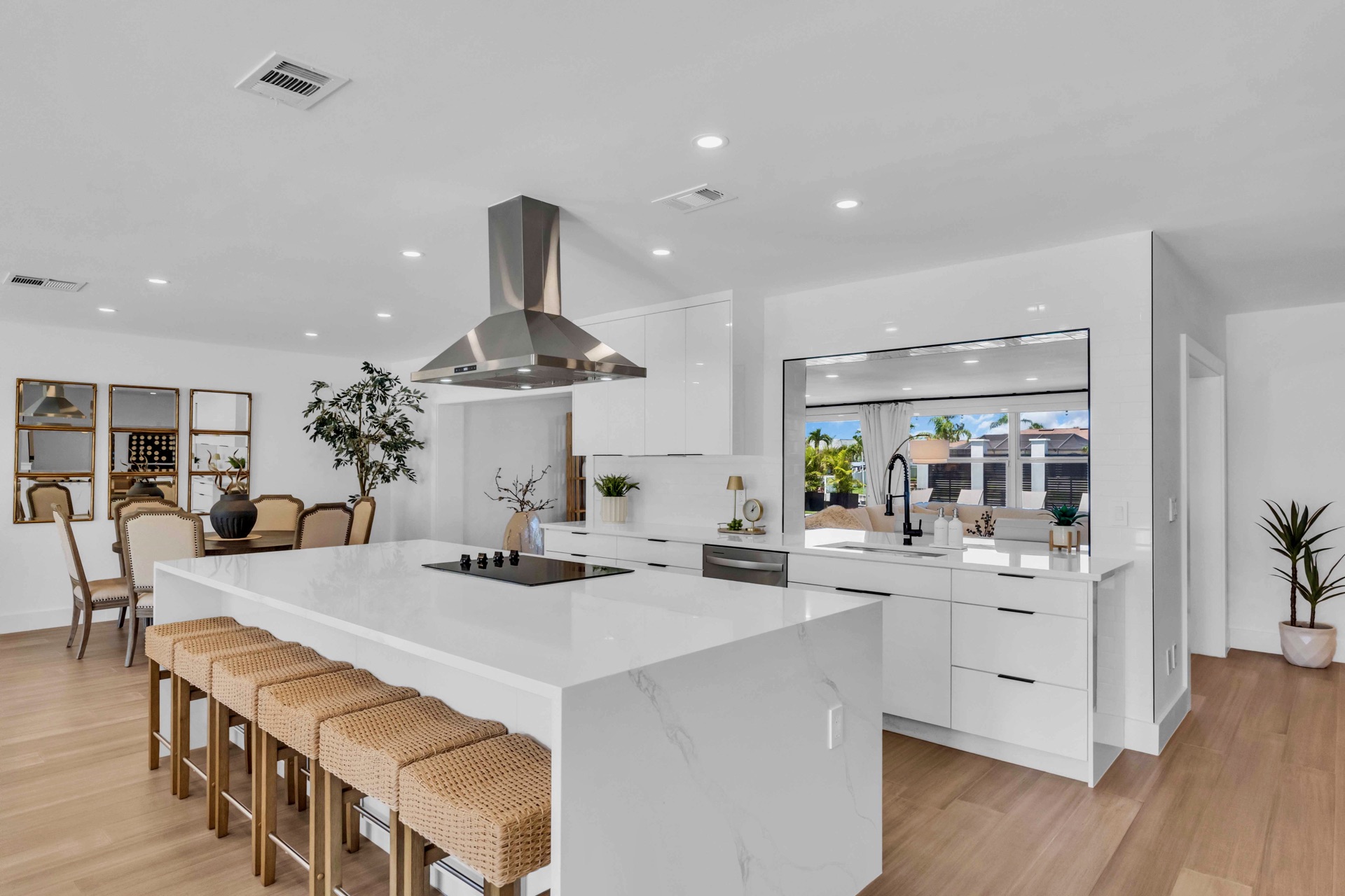 Chef's kitchen with waterfall quartz island and bar seating