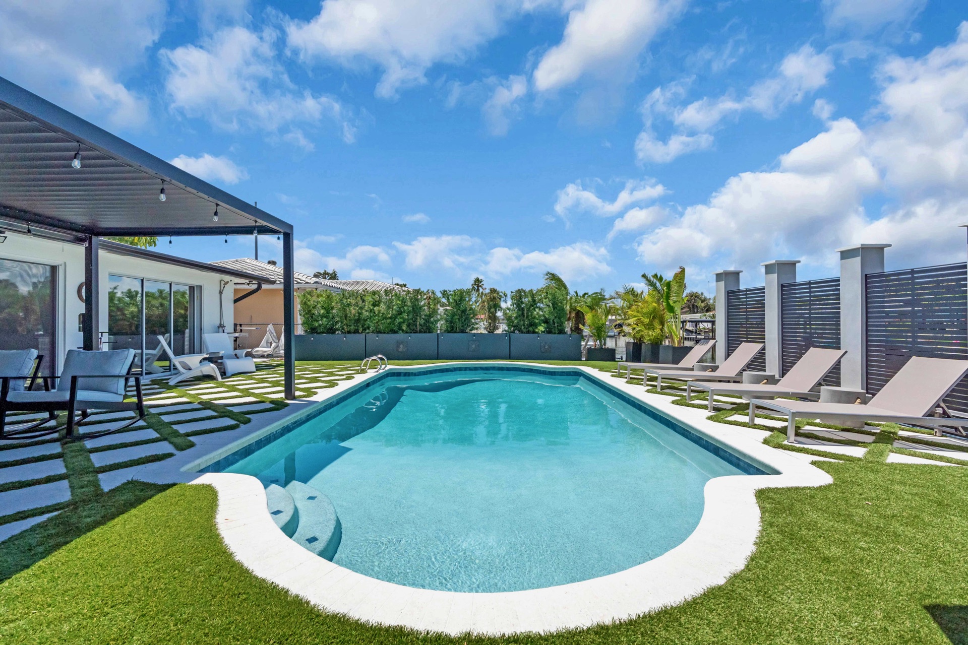 Resort-style pool and turf lawn at golden hour